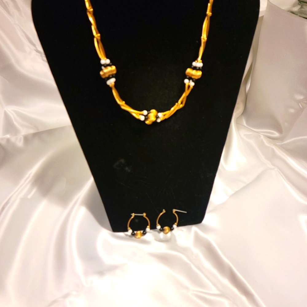 Avon black, gold and white 3- piece set.
